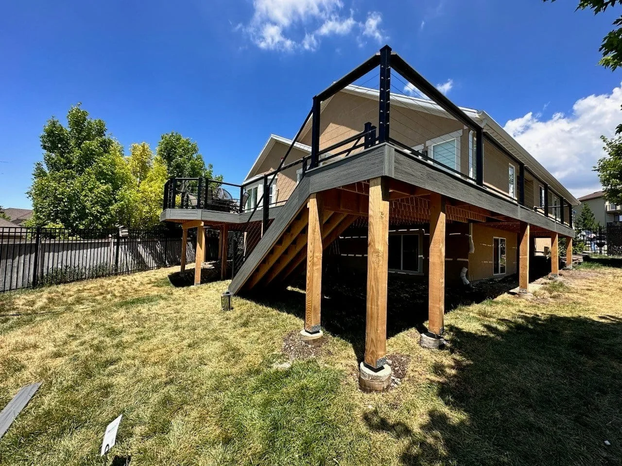 Elevated composite deck with exterior stairs