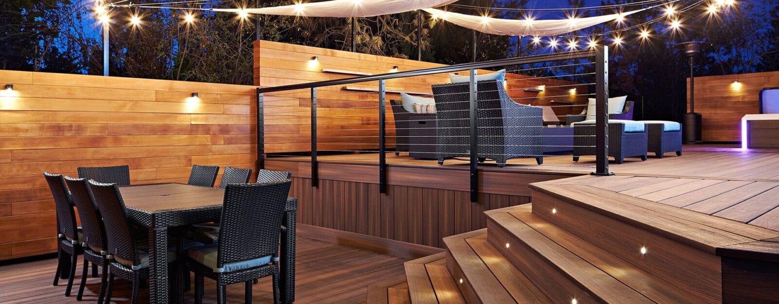 Finished composite deck with built-in lighting, stairs, and outdoor seating